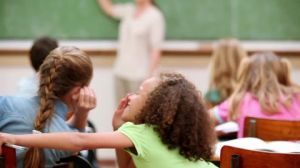 409751494-whispering-primary-school-pupil-attention-mysterious